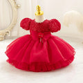 Robe bébé fille rouge à manches bouffantes et jupe en tulle superposée, idéale pour cérémonie ou Noël