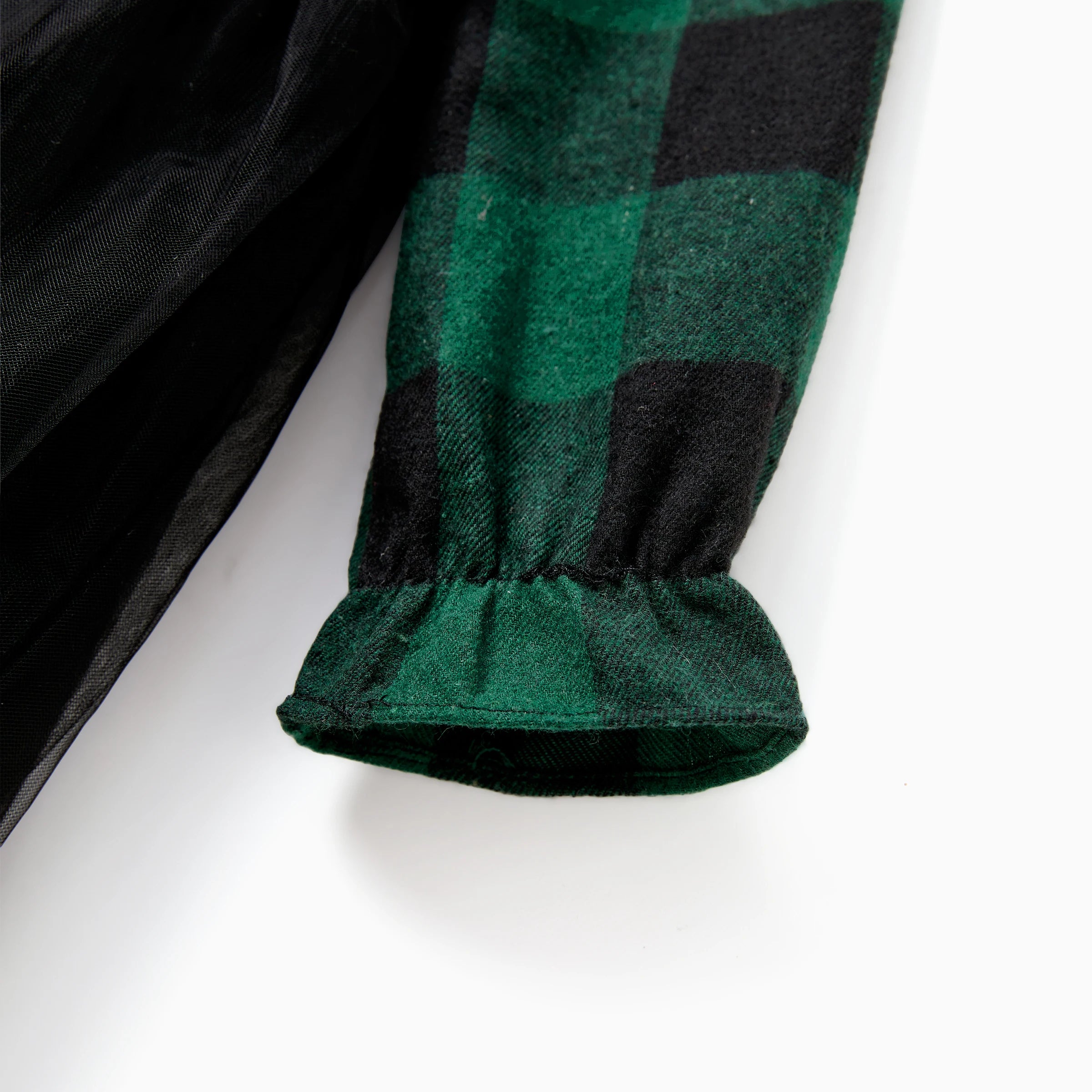 Détail de la manche froncée de la robe à carreaux verts et noirs