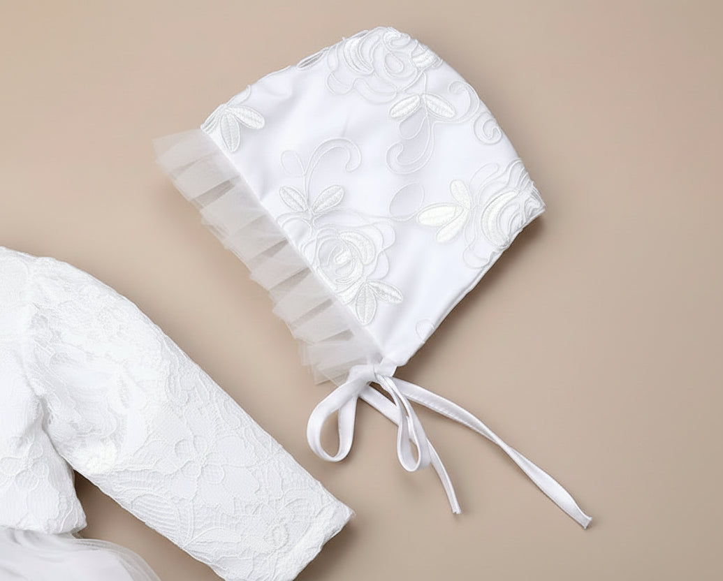 Détail du chapeau de baptême pour bébé en dentelle blanche avec rubans à nouer