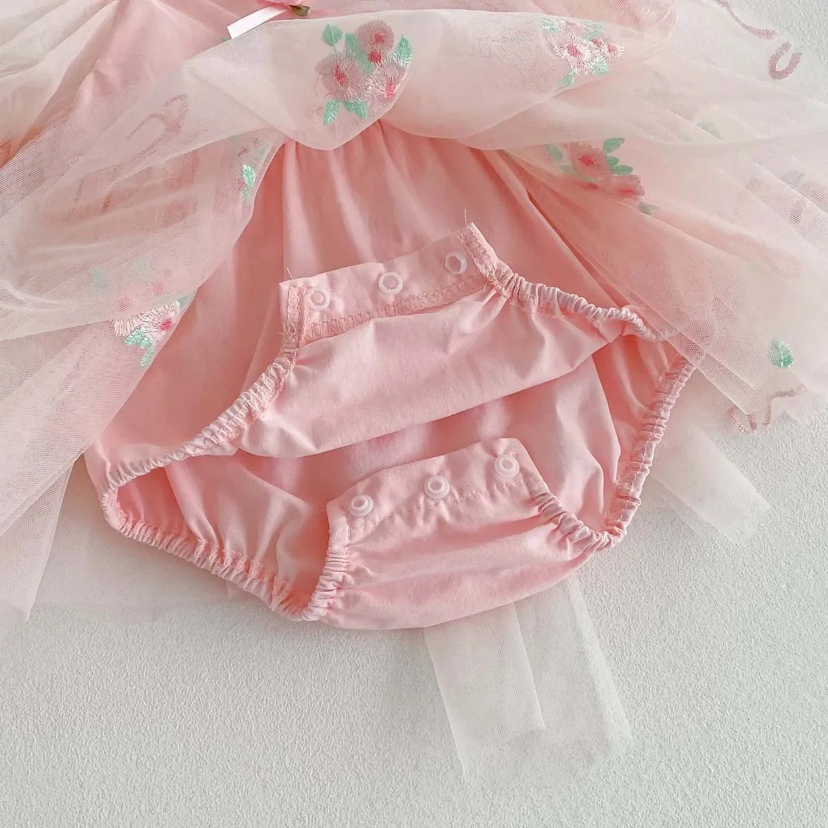 Détail de la barboteuse intégrée avec boutons pressions pour un change facile.