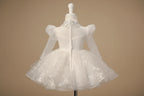 Vue de dos de la robe Juliana sur mannequin montrant la transparence du haut et le volume de la jupe